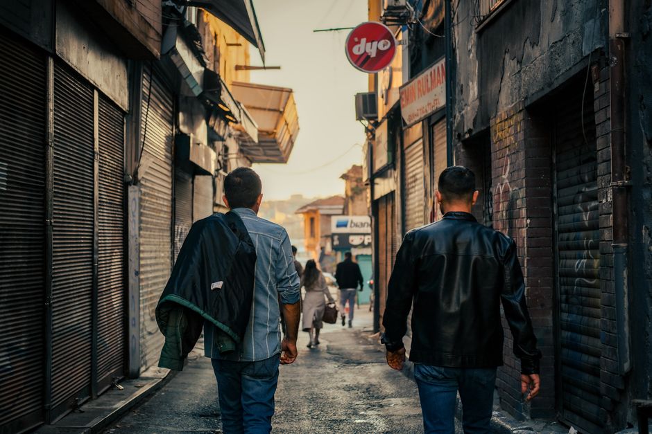 Men walking away from apartment