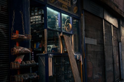 Free Dimly lit hardware store with tools and supplies in a vintage setting. Stock Photo