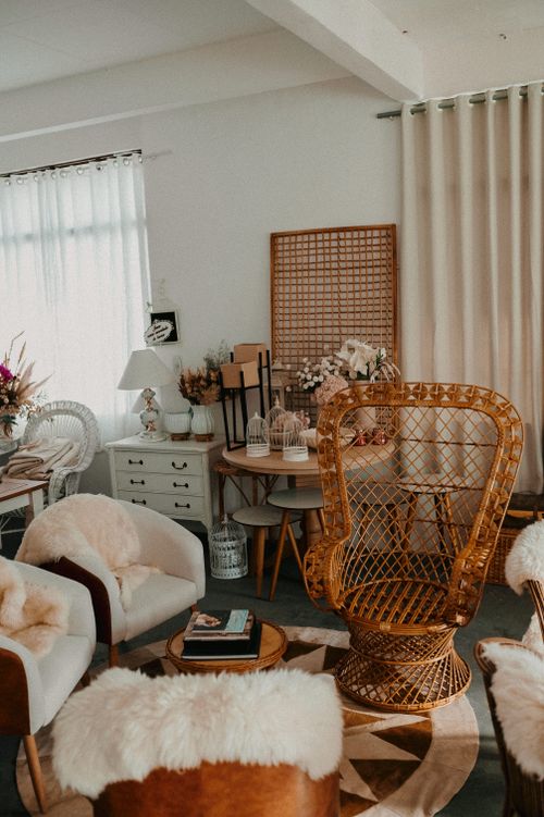 Free Warm bohemian-style living room with wicker and rustic accents. Stock Photo