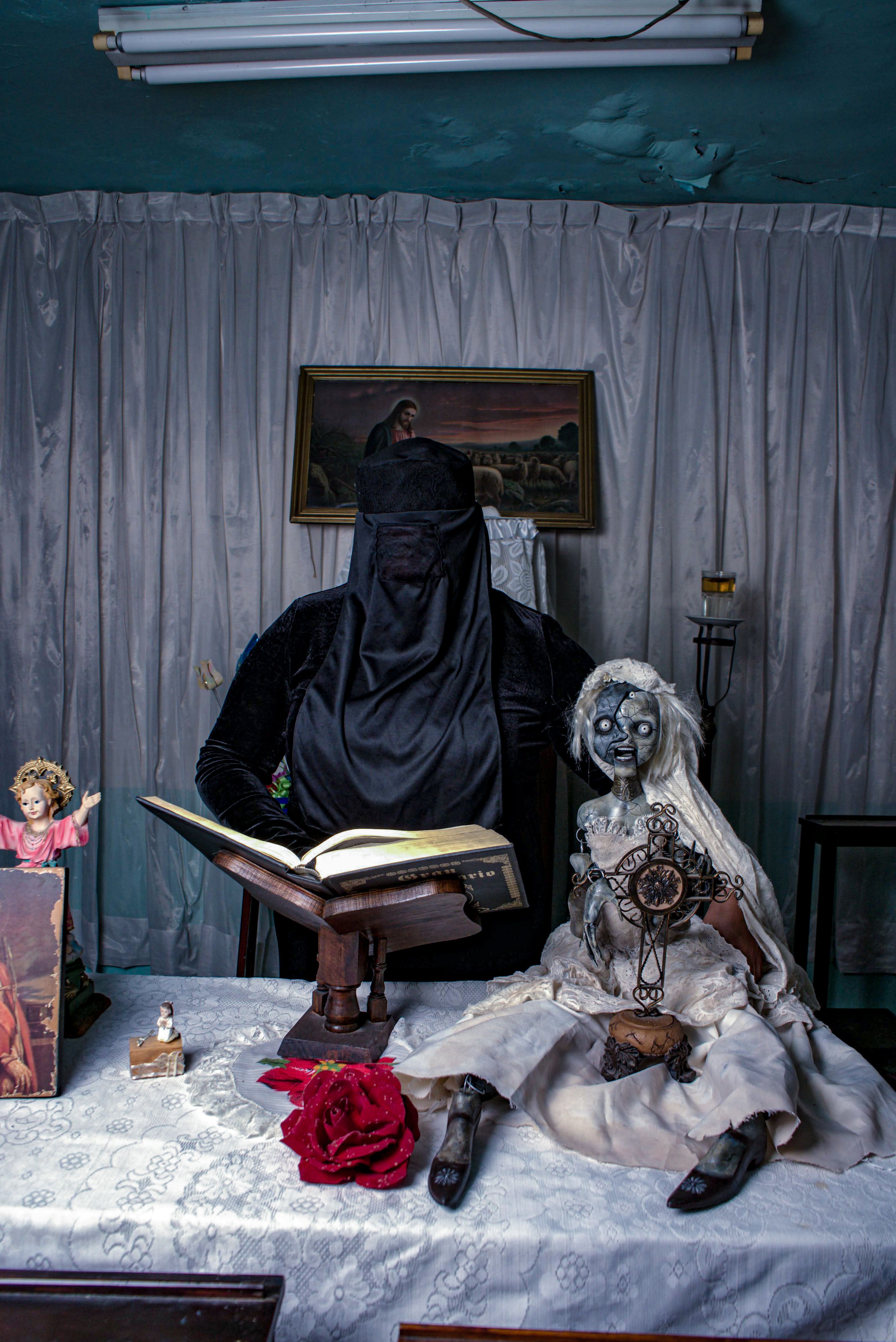 Mysterious Figure with Creepy Doll in Dim Room · Free Stock Photo