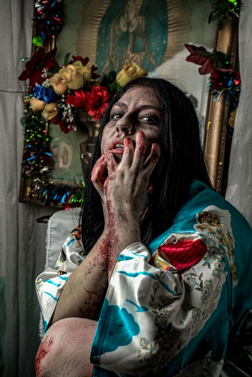 Free Dramatic horror portrait of a blood-covered woman in a floral robe. Stock Photo
