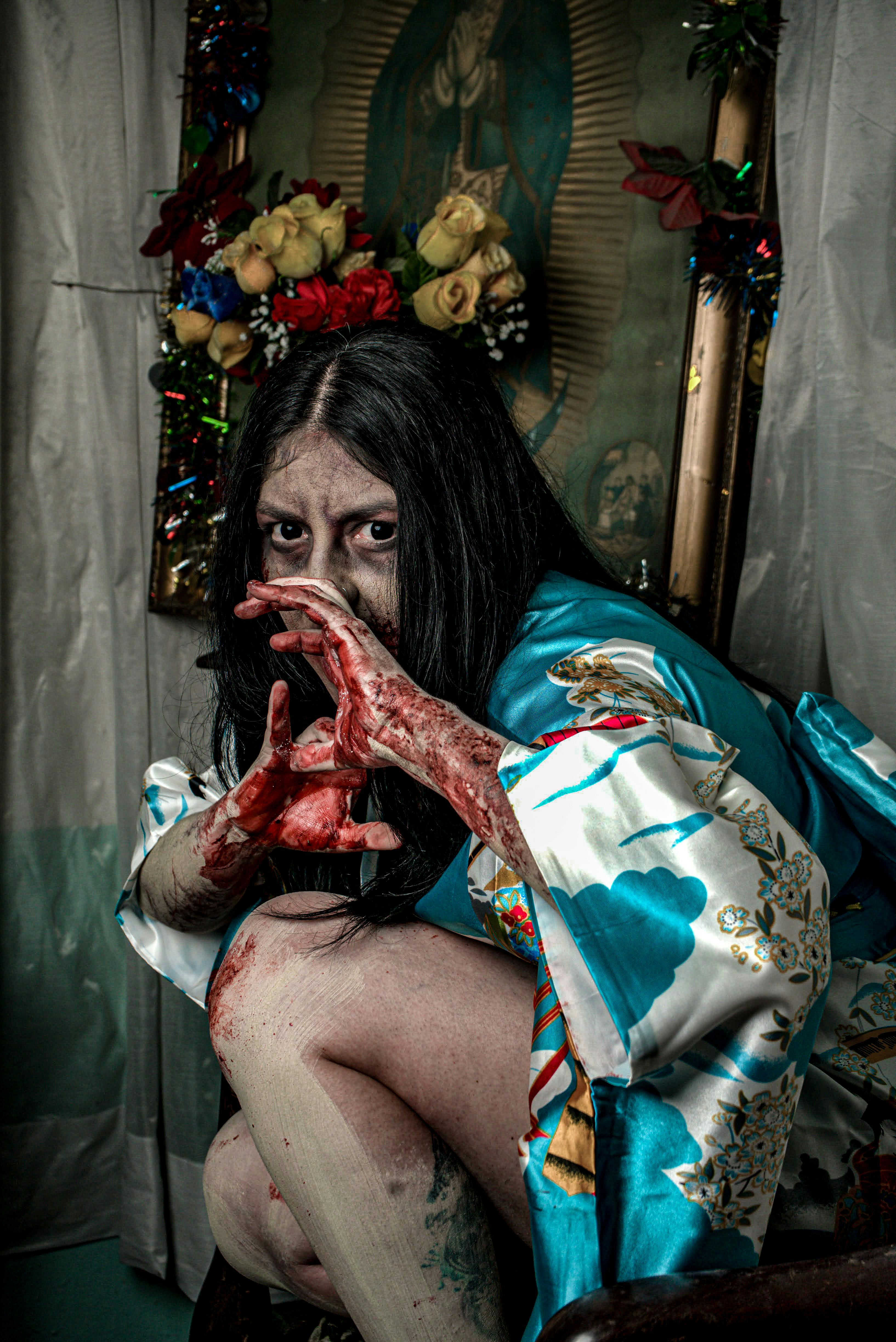 Intriguing portrait of a woman in traditional attire with a dramatic and eerie expression.