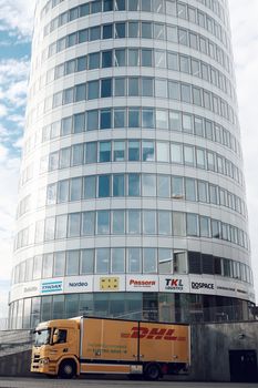 A cylindrical office building with a DHL truck parked in Jönköping, Sweden.