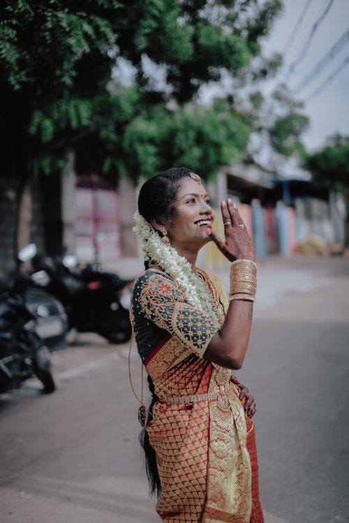 Free Indian bride in a vibrant traditional sari smiling joyfully outdoors. Stock Photo