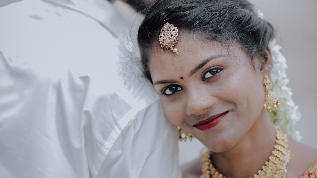 Smiling couple in traditional attire at an outdoor wedding (Destination Event Catering in Vellore)