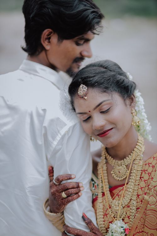 Free Elegant Indian couple in traditional attire sharing a tender moment outdoors. Stock Photo
