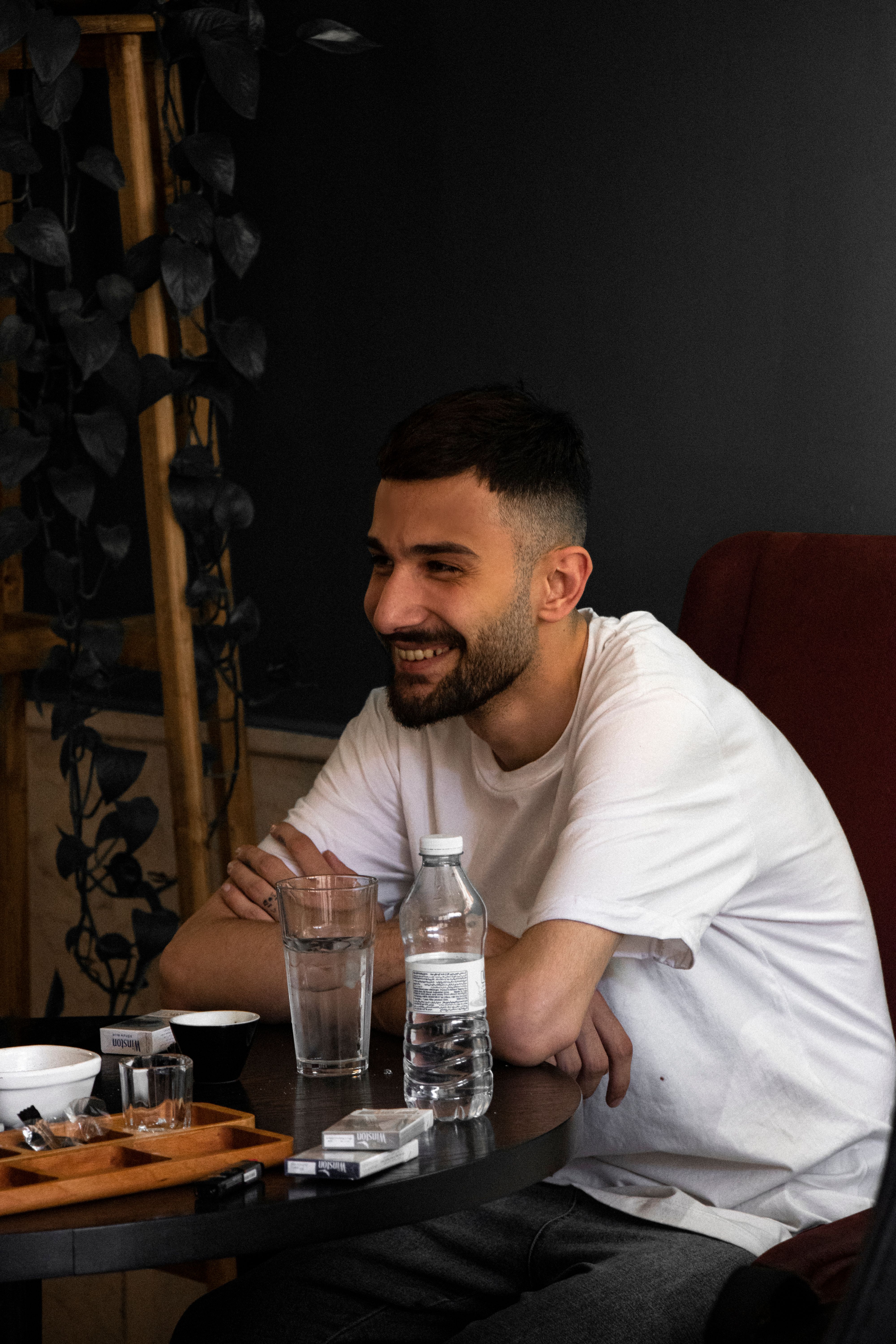 Young man enjoying a relaxed moment at a café in Tabriz, Iran. Warm and inviting atmosphere.