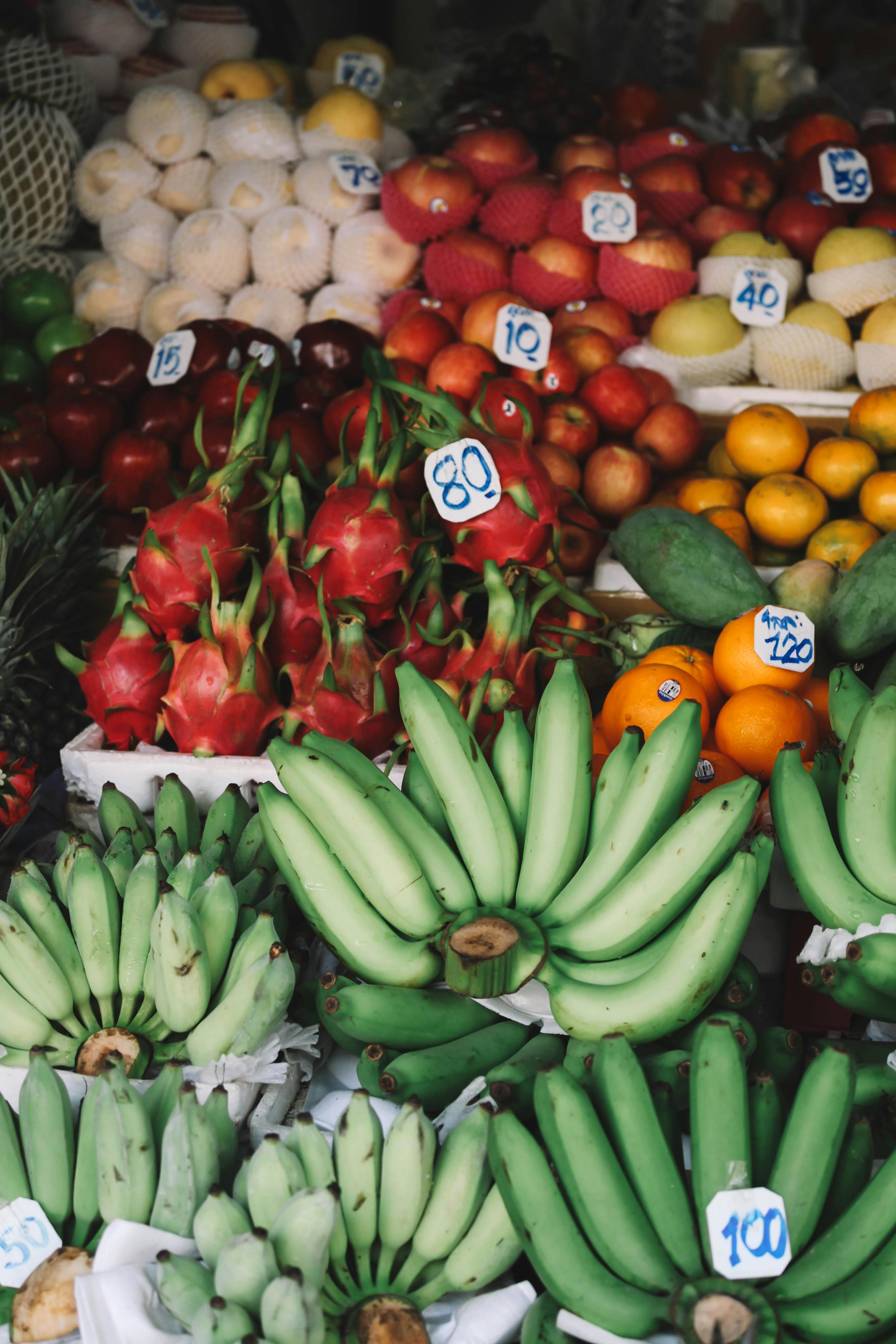 Colorful tropical fruits displayed at a bustling Bangkok market, showcasing Thailand's rich produce variety.