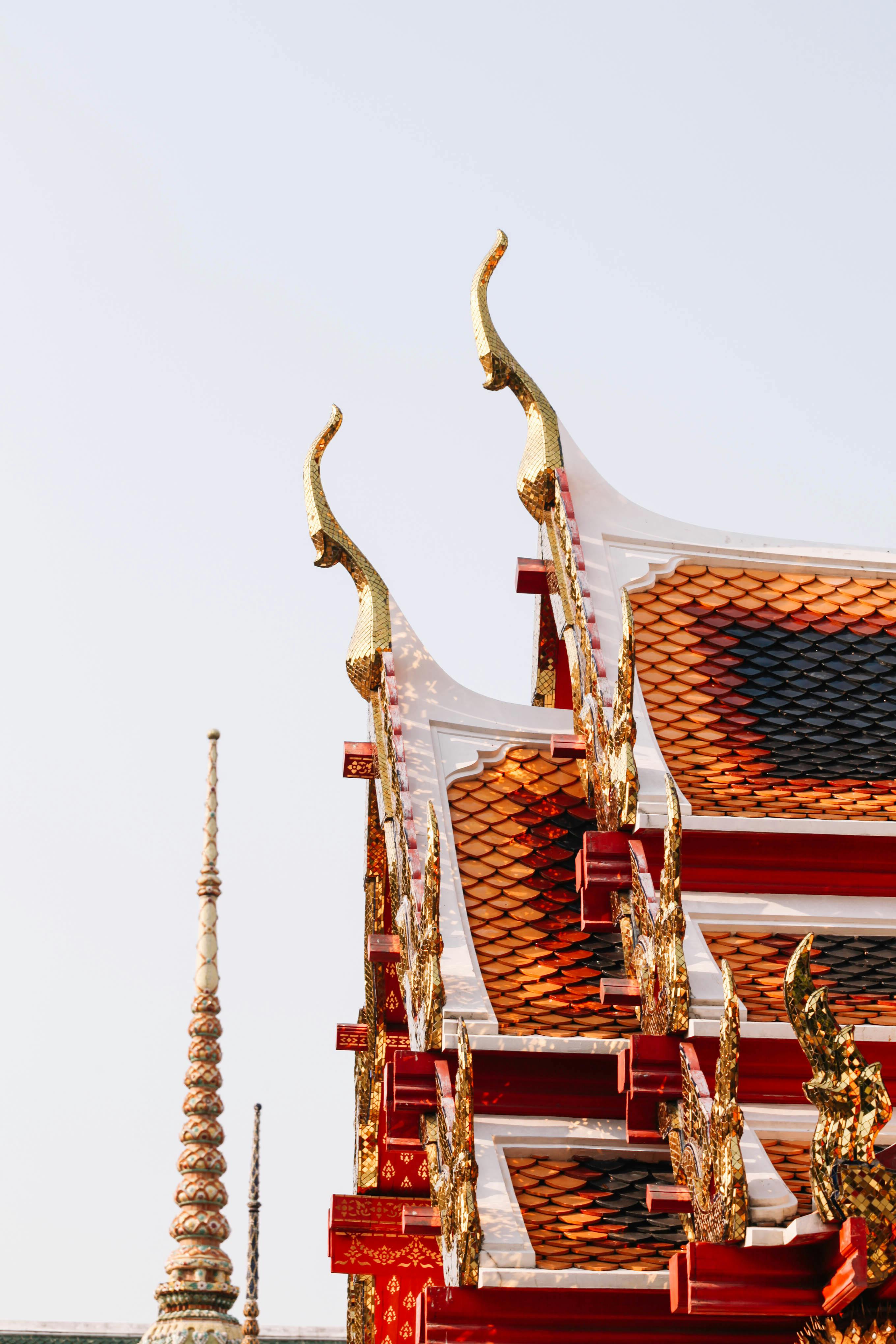 Intricate details of Thai architecture at The Grand Palace in Bangkok, showcasing vibrant colors and traditional design.