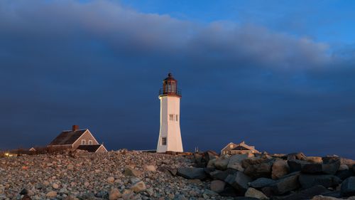 Free Beautiful twilight view of the historic Scituate Lighthouse in Massachusetts against a dramatic sky. Stock Photo