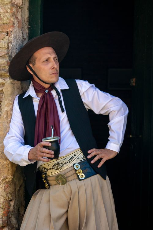 Free Authentic Argentinian gaucho enjoying mate in traditional attire. Stock Photo