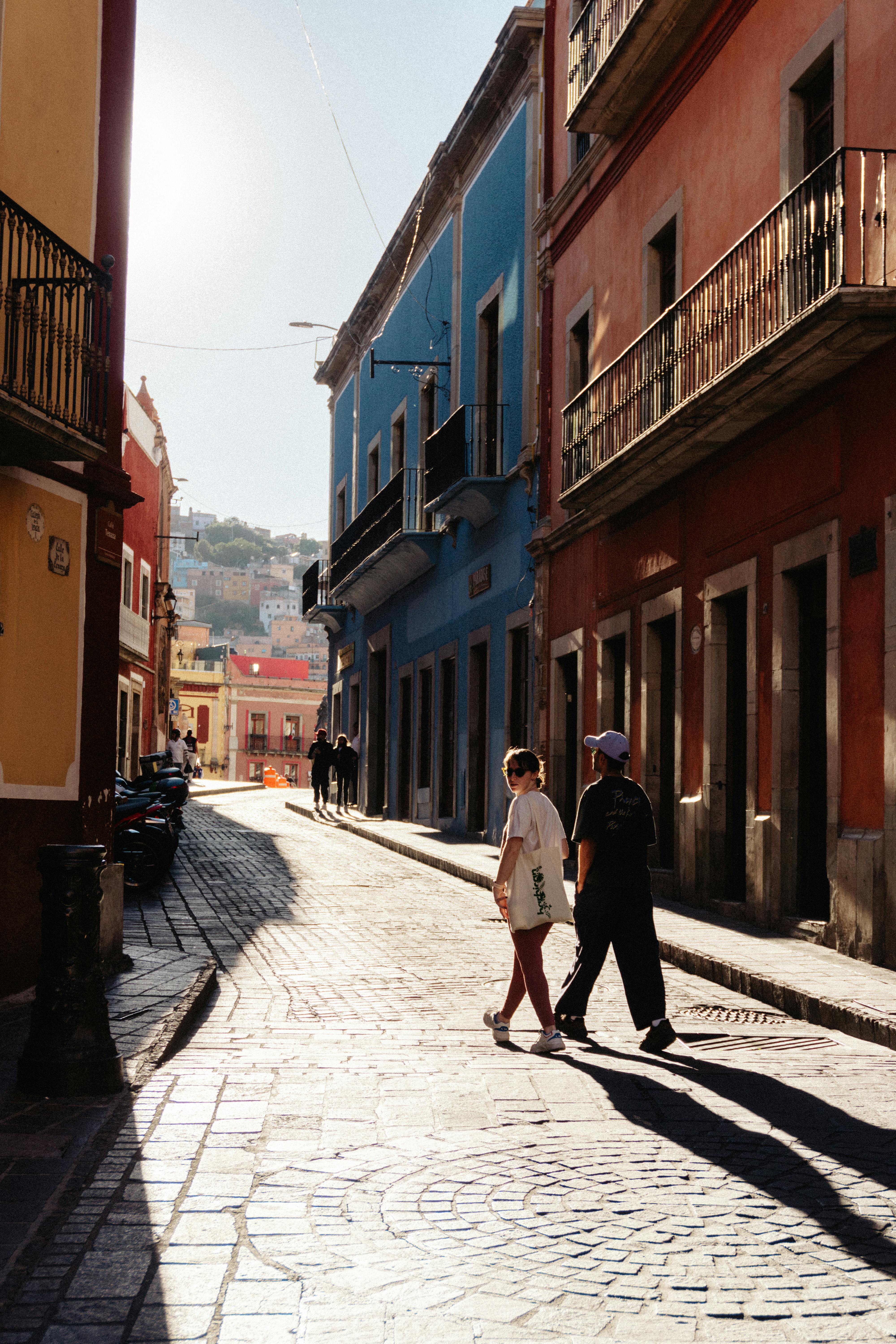 A colorful street in Guanajuato, Mexico, showcases historic architecture and vibrant hues.