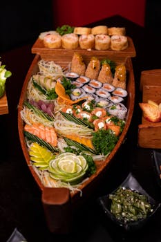 A colorful assortment of sushi and sashimi served on a wooden boat platter, ideal for authentic Japanese dining.