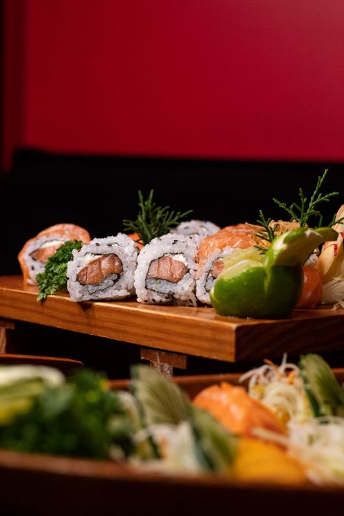Free Delicious sushi rolls artfully arranged on a wooden platter, perfect for culinary promotions. Stock Photo