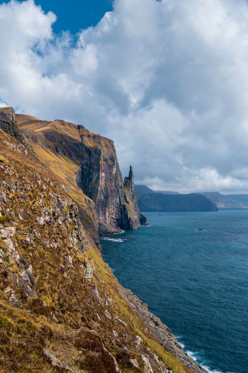 Free Stunning view of Trøllkonufingur's mossy cliffs against the Atlantic in the Faroe Islands. Stock Photo