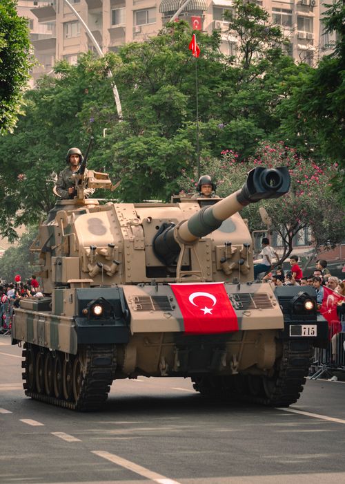Free Turkish military tank with flag parading through Adana, Türkiye, during a national celebration. Stock Photo