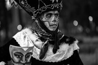 Captivating black-and-white portrait of a Catrin in traditional costume and skull makeup, Mexico City.