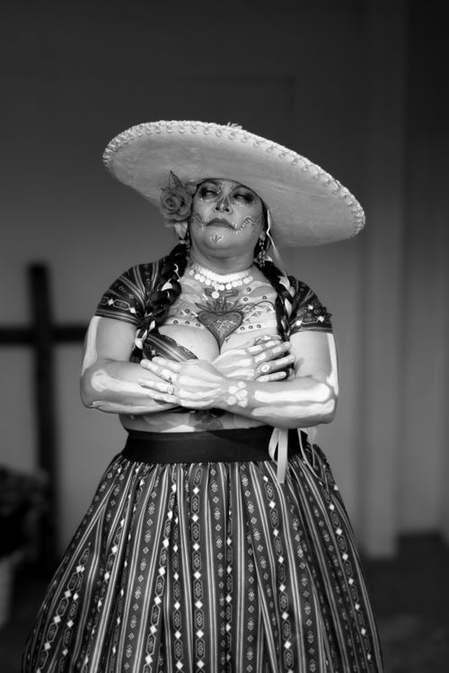 Free Black and white portrait of a woman in Day of the Dead attire with face paint and traditional dress. Stock Photo