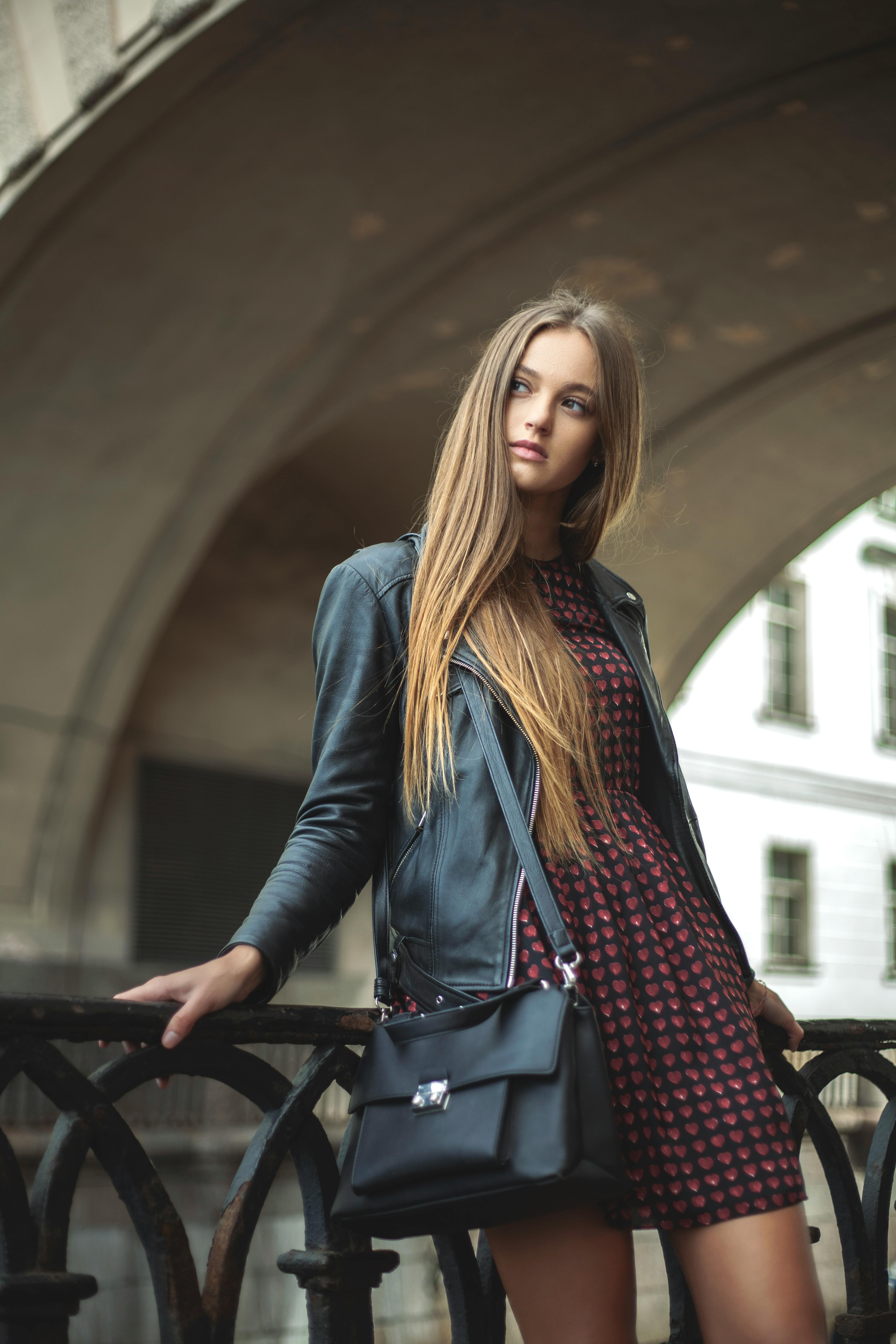 Woman in Black Leather Jacket Holding Metal Chain · Free Stock Photo