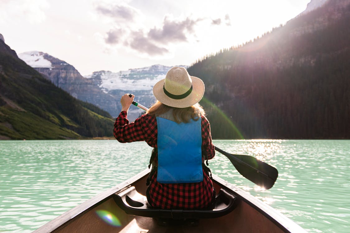 Free A Woman Paddling A Boat In The Lake Stock Photo
