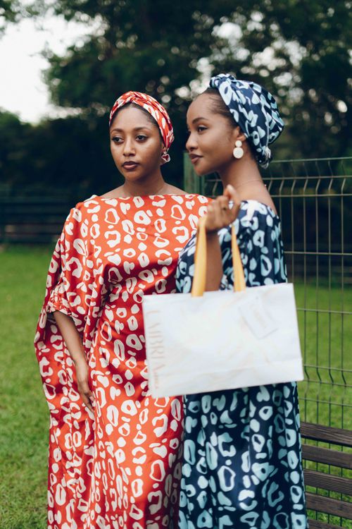 Free Two women showcasing African fashion in colorful attire outdoors in Nigeria. Stock Photo
