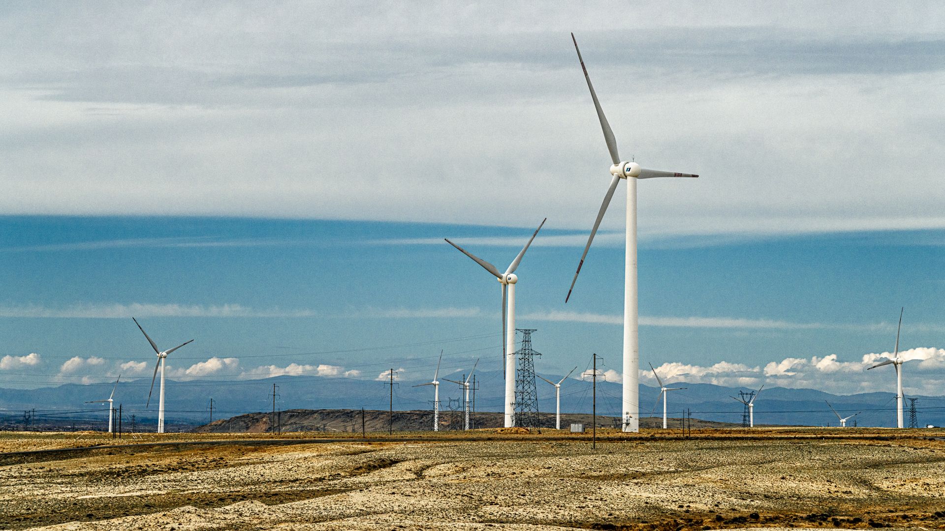A landscape of numerous wind turbines generating renewable energy on a clear day.