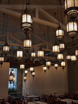 Elegant hanging lanterns create a warm ambiance in a stylish indoor cafe in Odessa, Ukraine.