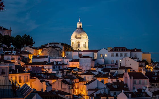 Discover the enchanting night skyline of Lisbon, featuring iconic architecture and vivid city lights.