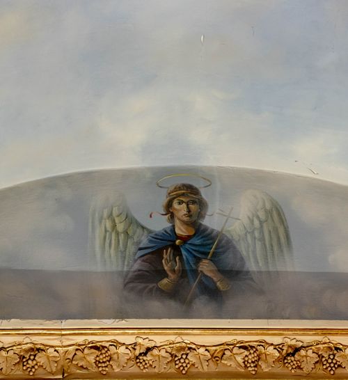 Free A detailed fresco of an angel with a halo and cross, evoking spiritual themes. Stock Photo