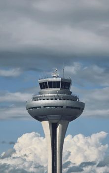 Photo of Frankfurt Airport's control tower standing tall against a dramatic cloudy backdrop.