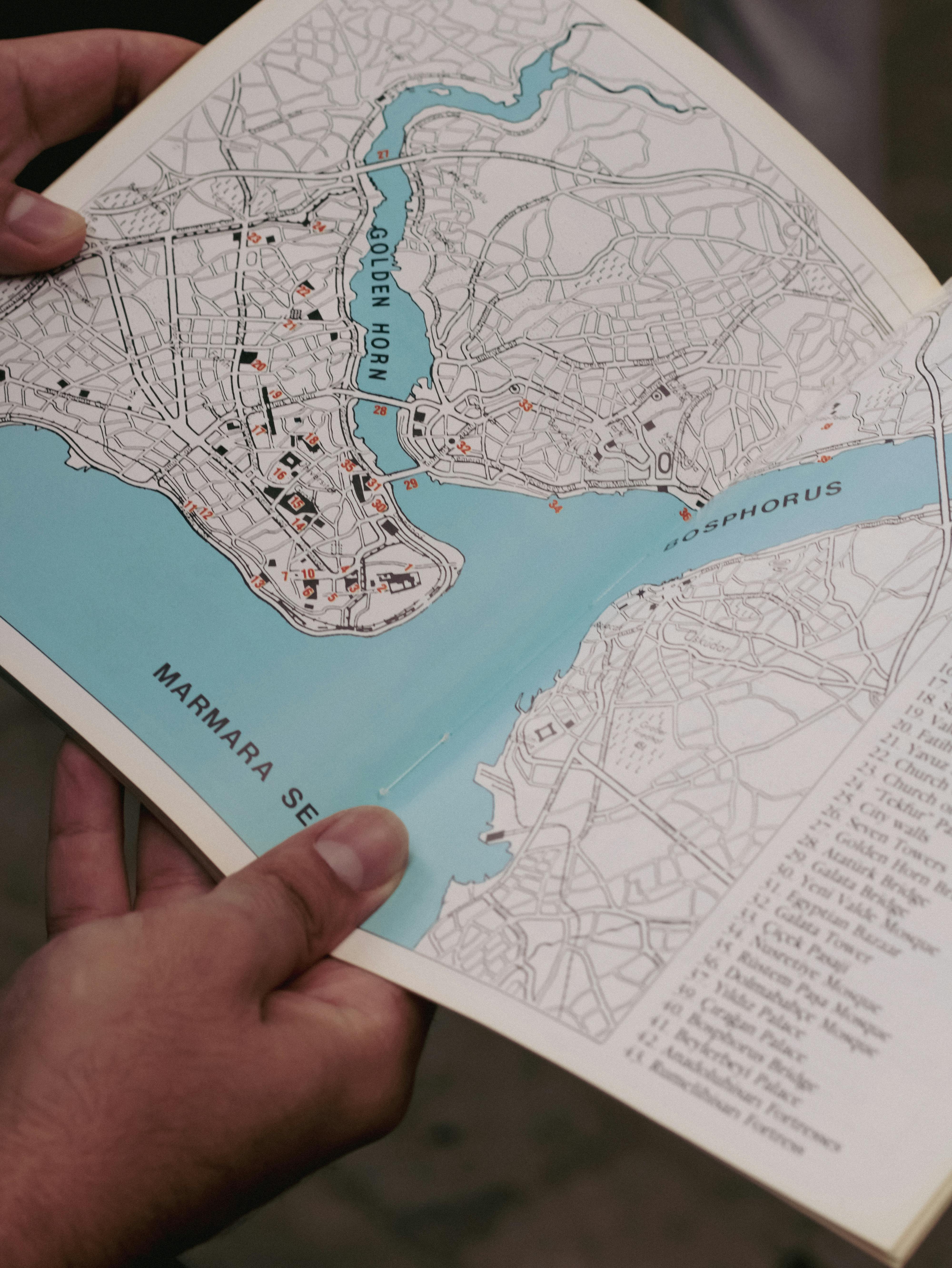 person holding map of istanbul with bosphorus