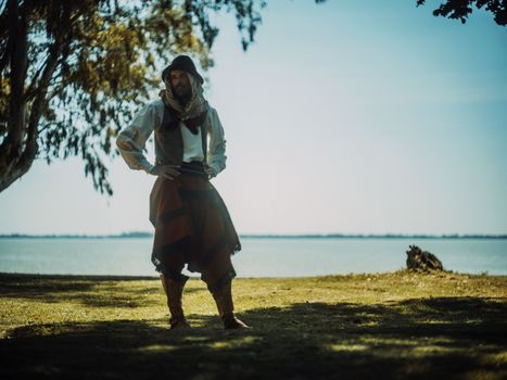 Gaucho in traditional clothing by Chascomús Lake, Argentina.