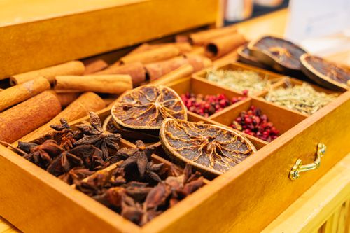 Free Close-up of various spices in a wooden box, including dried citrus, cinnamon, and star anise. Stock Photo