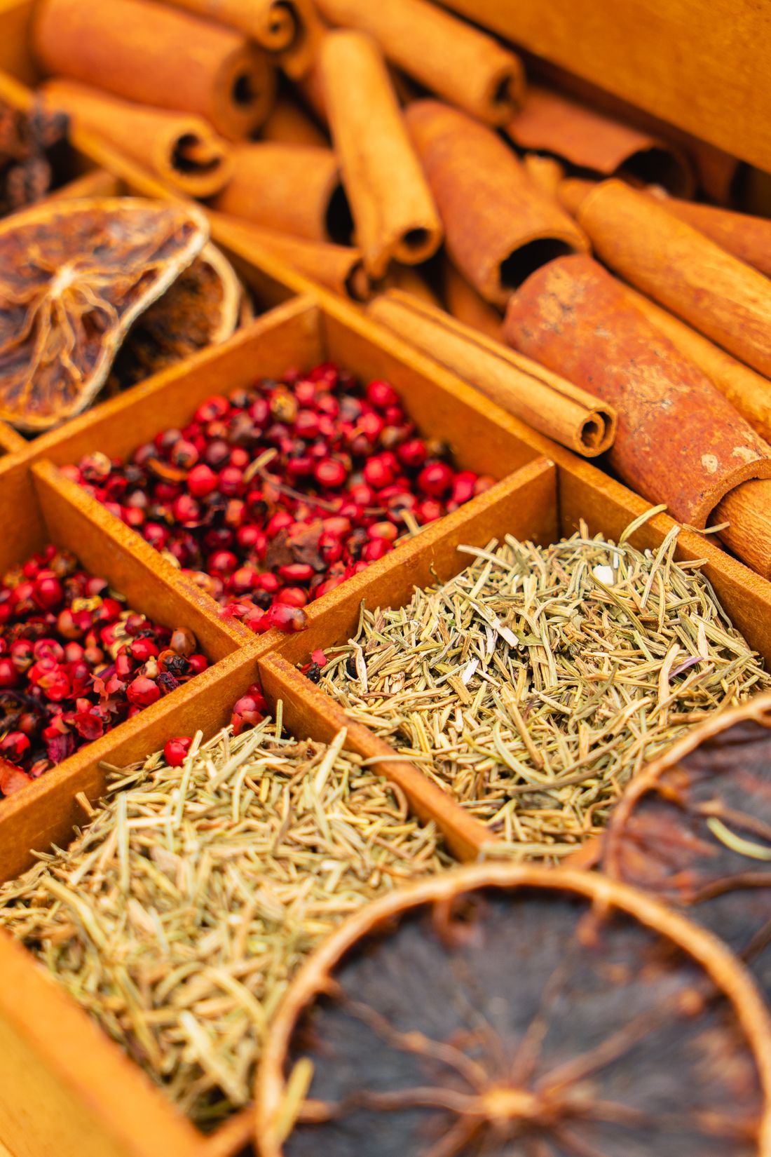 Dried spices and herbs arranged in wooden boxes