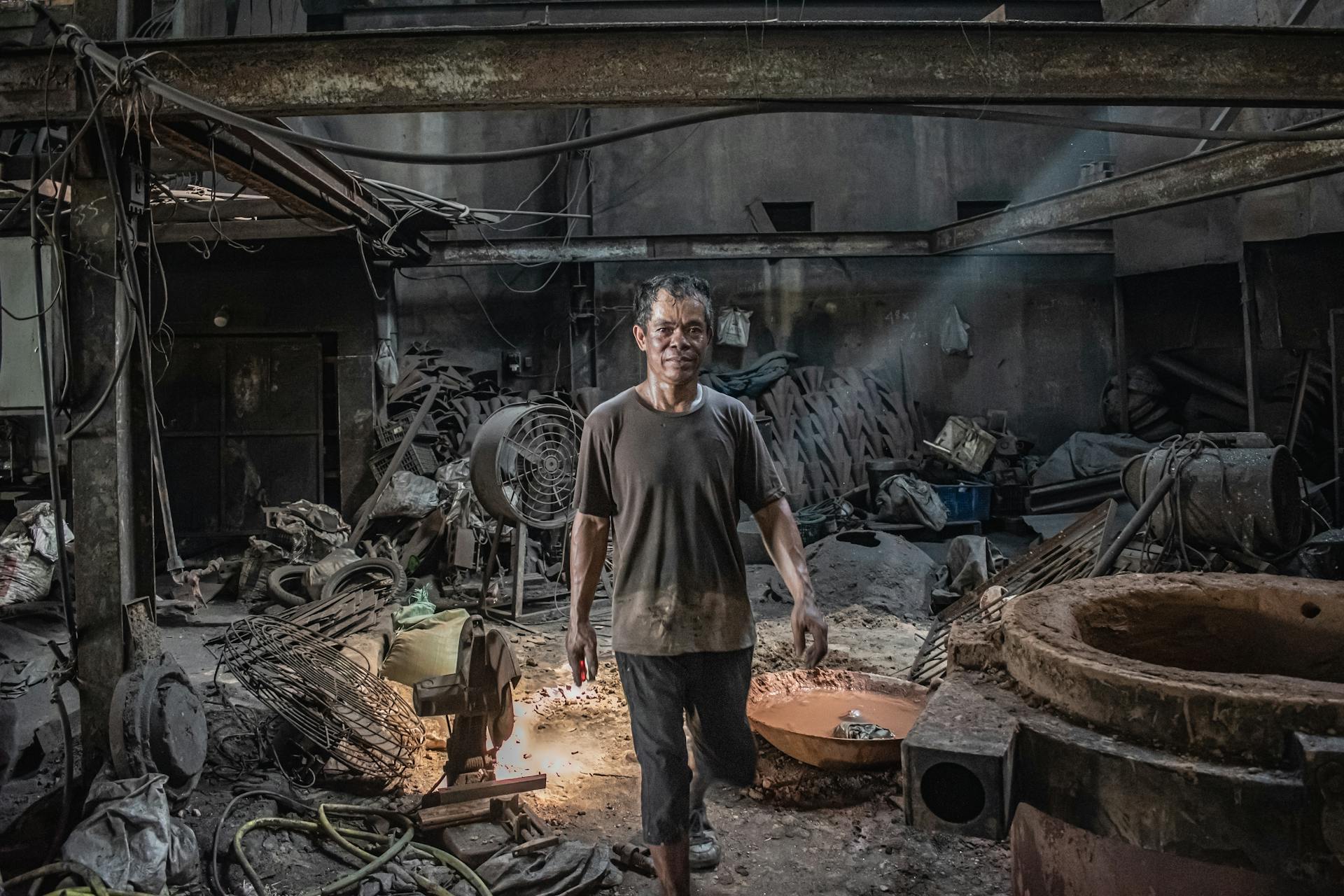 A Vietnamese artisan in Hai Phong creating iron crafts with traditional techniques.