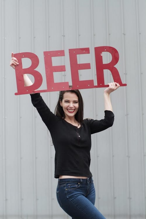 Woman Lifting Beer Signage