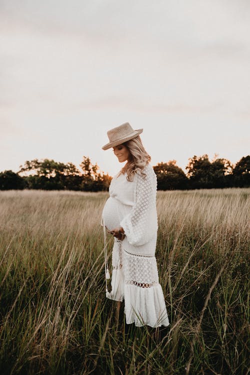 Free Photo Of Pregnant Woman Standing On Field Stock Photo
