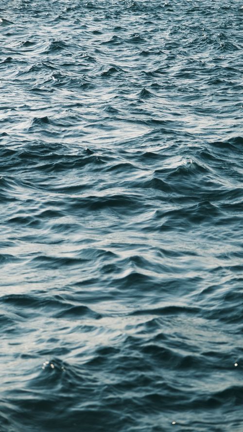 Free Peaceful ocean waves gently rippling across the sea in a calming scene. Stock Photo
