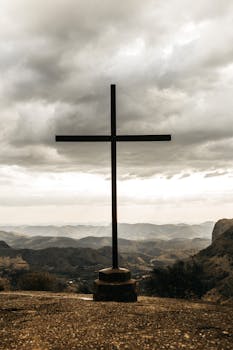 black cross on top of mountain