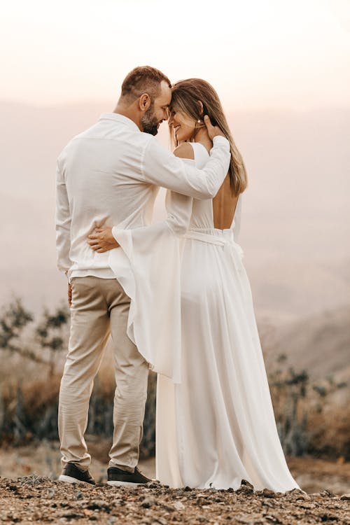Free Man and Woman in White Dress and Suit Stock Photo