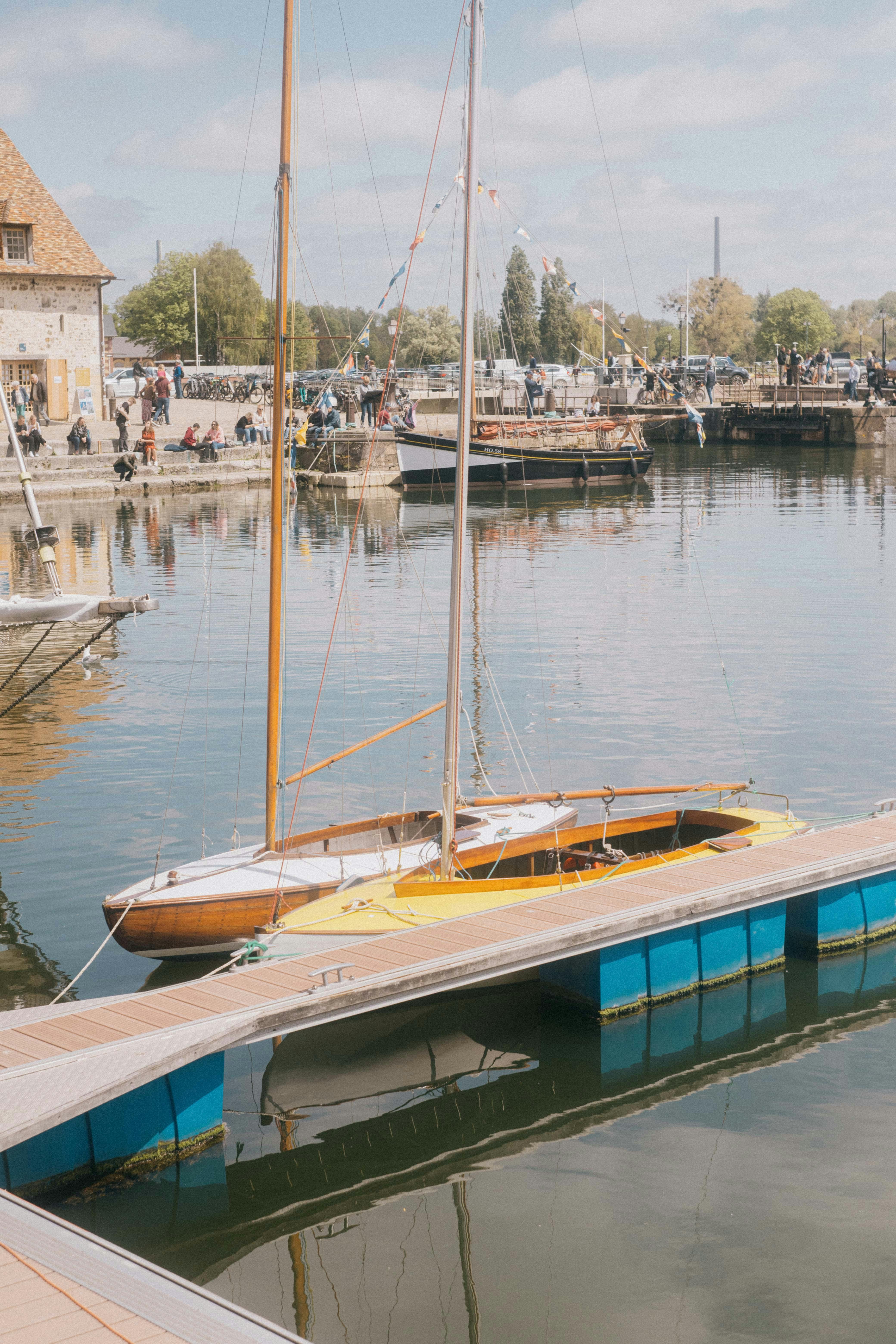 Picturesque scene of boats reflecting in Honfleur Harbor, France.