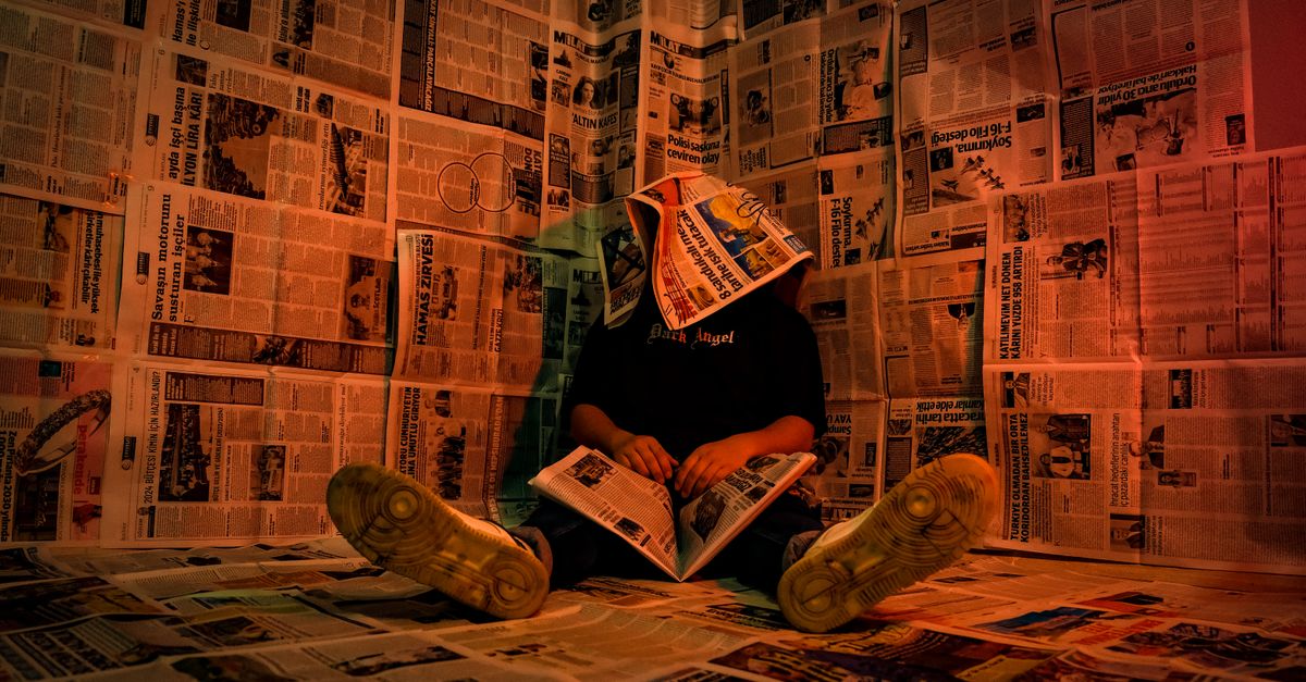 A person clicking a hyperlink on a laptop with a skeptical expression, surrounded by newspaper headlines