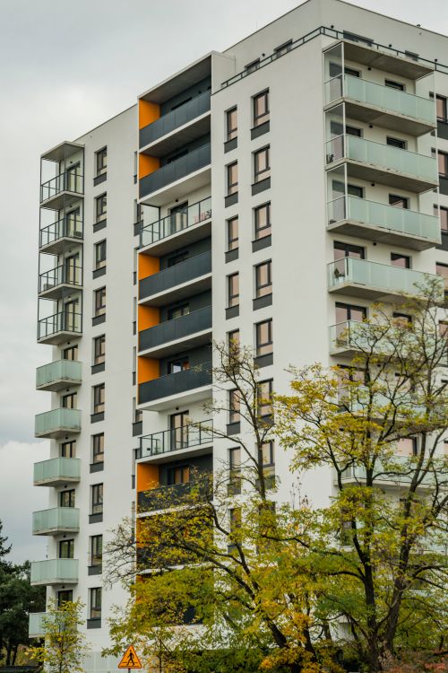 Free Contemporary apartment building surrounded by autumn trees. Stock Photo