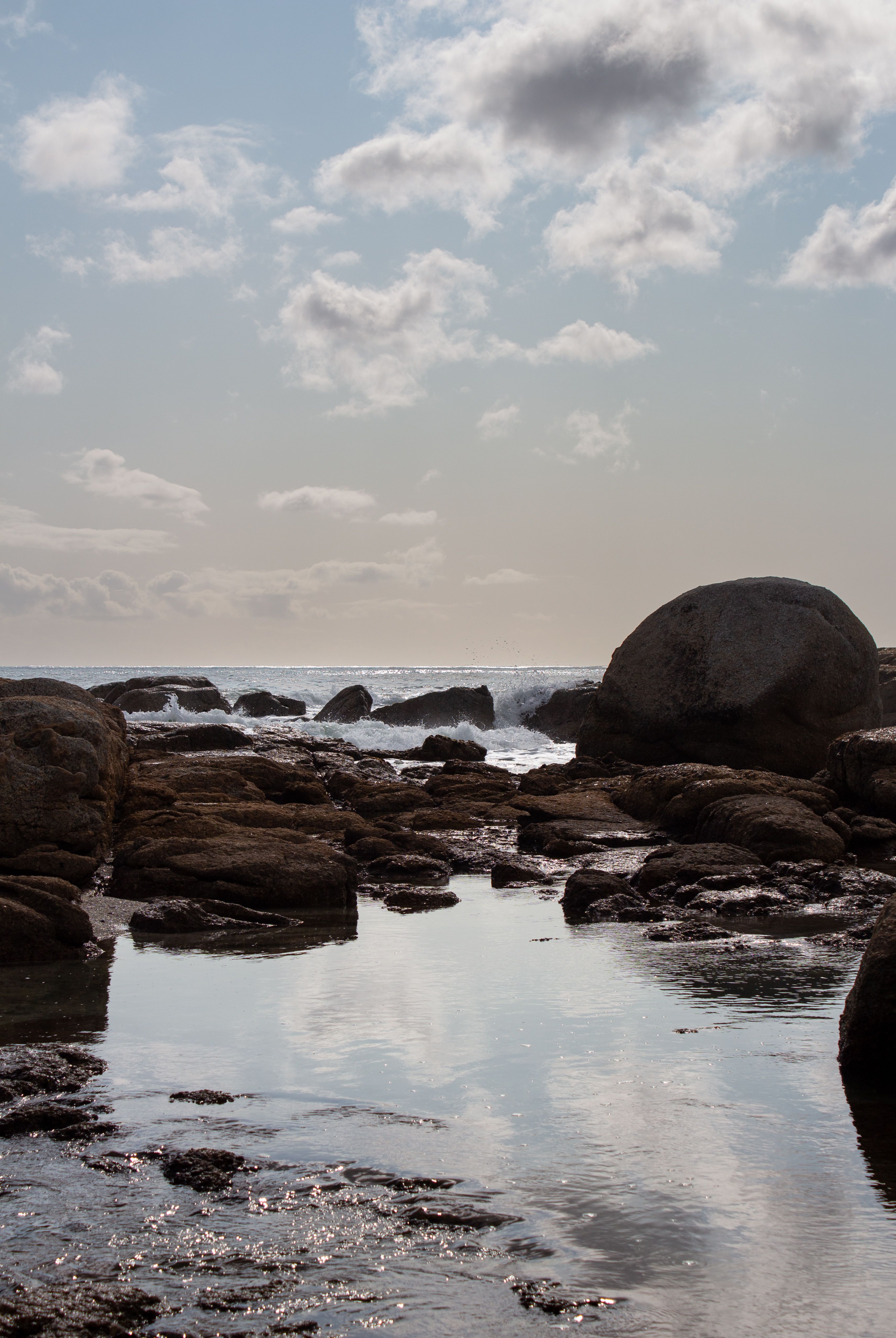 Serene Coastal Rocks Under a Cloudy Sky · Free Stock Photo