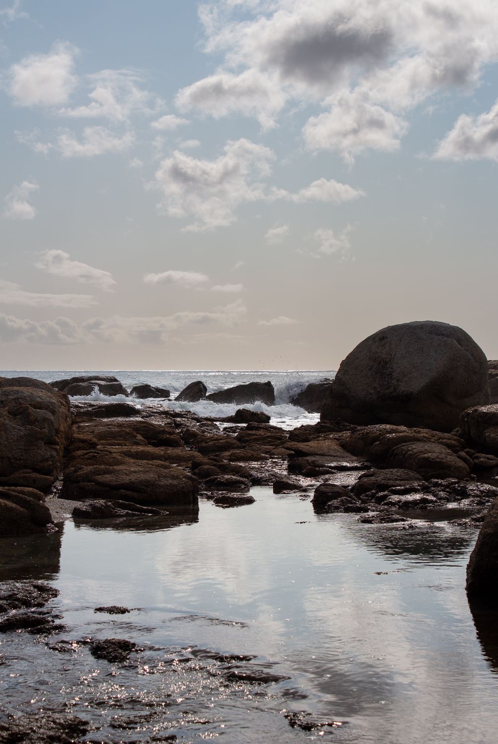 Serene Coastal Rocks Under a Cloudy Sky · Free Stock Photo