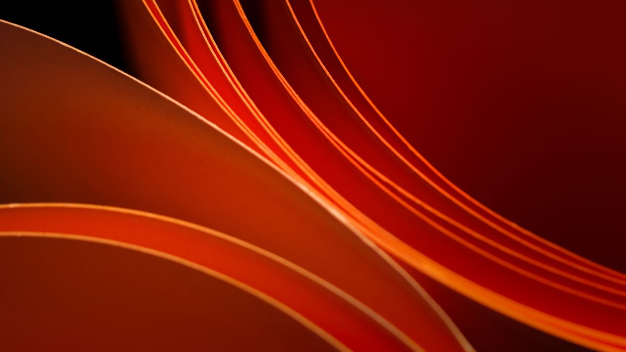 a striking abstract composition featuring vibrant orange curved paper