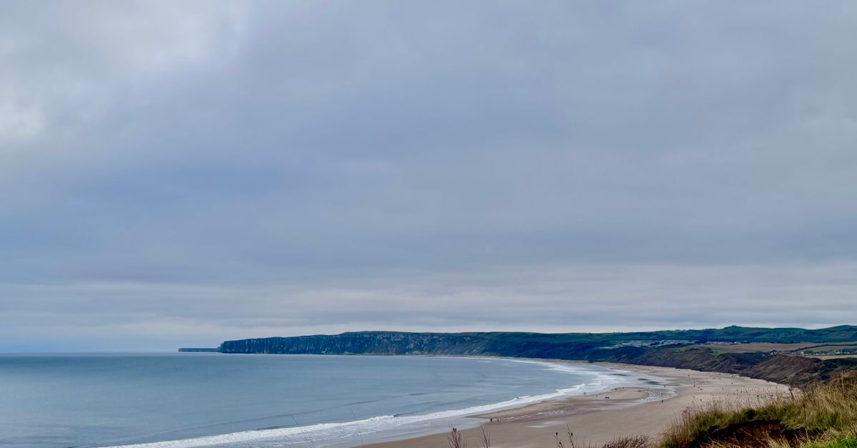 Explore the stunning coastline of Bridlington Beach, England, with dramatic cliffs and wide sands.