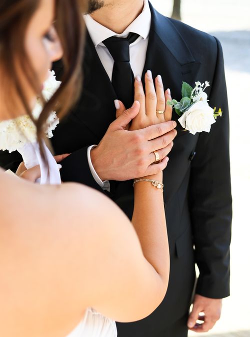 Free Intimate close-up of a couple holding hands at their wedding ceremony. Stock Photo
