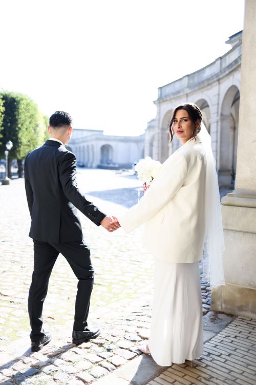 Free Bride and groom holding hands outdoors, showcasing love and elegance. Stock Photo