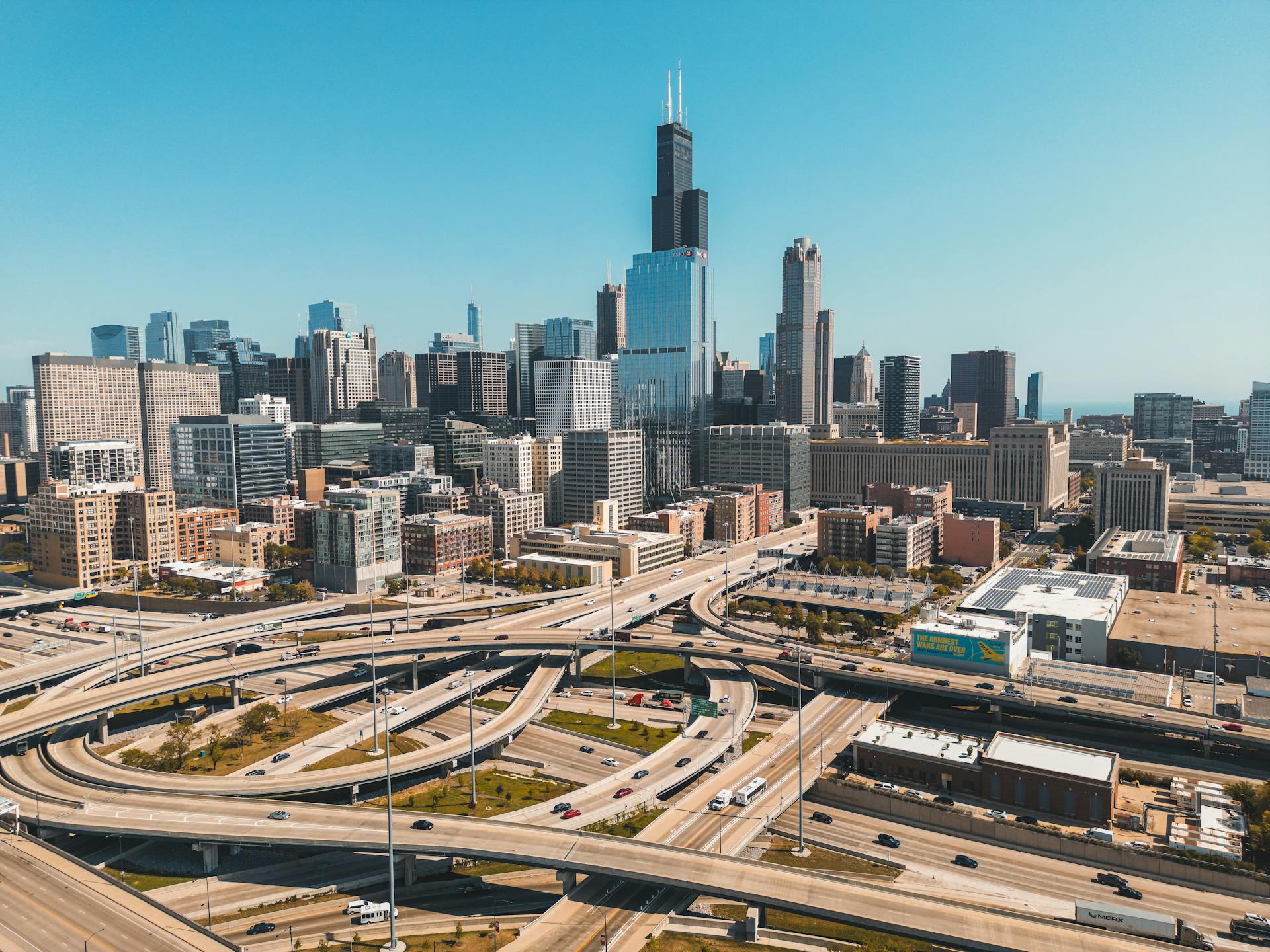 Aerial perspective of Chicago cityscape featuring Willis Tower on a sunny day.